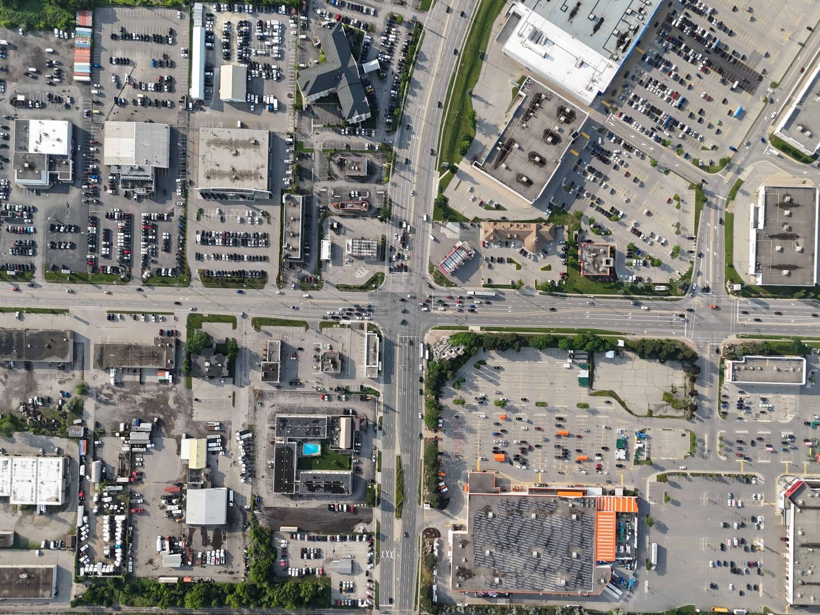 An aerial view of a commercial and industrial area with various buildings, parking lots, and roads in Waterloo, Ontario, Canada